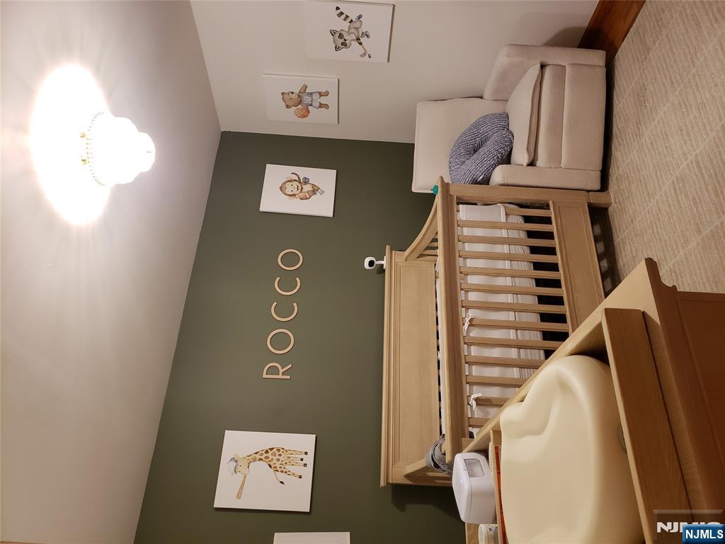 152 Miller Avenue, Unit 2 Elmwood Park, NJ 07407 - Photo 8 of 15 a bedroom with a bed and a couch