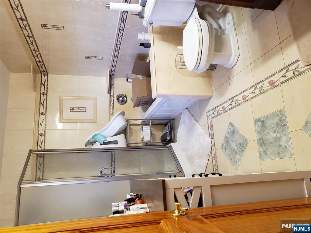 152 Miller Avenue, Unit 2 Elmwood Park, NJ 07407 - Photo 9 of 15 a bathroom with a sink toilet and shower