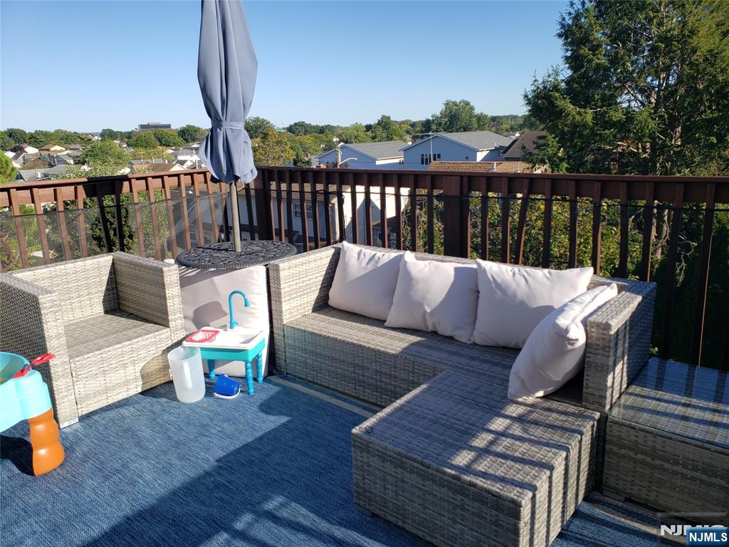 152 Miller Avenue, Unit 2 Elmwood Park, NJ 07407 - Photo 10 of 15 a roof deck with couches and wooden floor