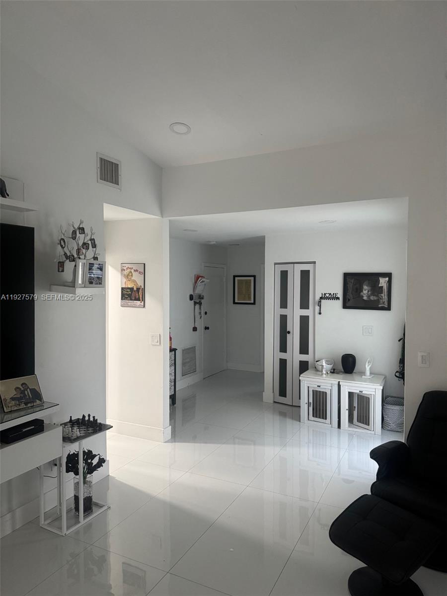 1131 Southwest 110th Avenue Pembroke Pines, FL 33025 - Photo 2 of 9 a living room with furniture and a flat screen tv