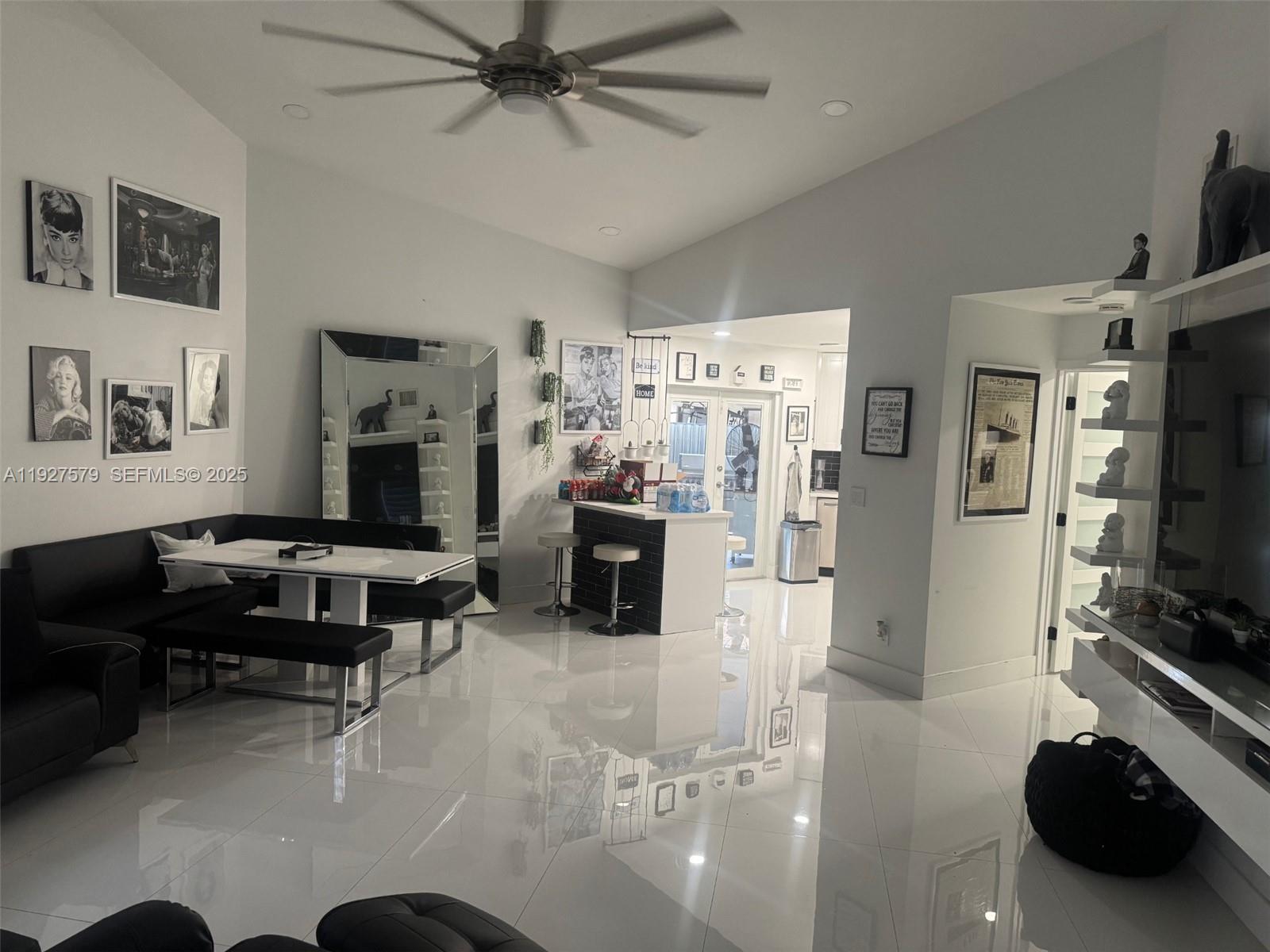 1131 Southwest 110th Avenue Pembroke Pines, FL 33025 - Photo 3 of 9 a view of a livingroom with workspace and a couch