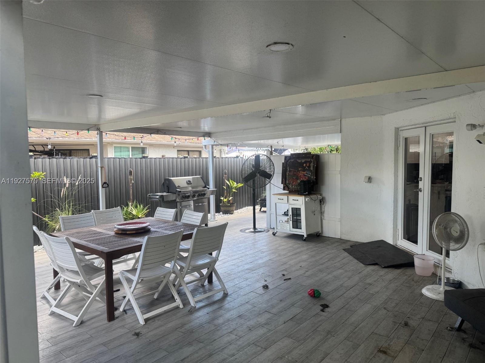 1131 Southwest 110th Avenue Pembroke Pines, FL 33025 - Photo 5 of 9 a dining room with furniture and wooden floor