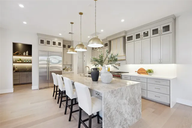 a kitchen with granite countertop white cabinets and stainless steel appliances