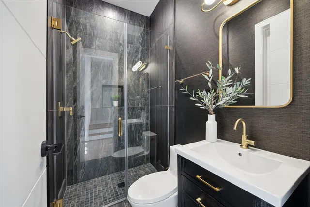 a bathroom with a sink toilet and shower