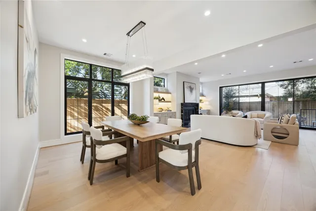 a living room with fireplace furniture and a large window