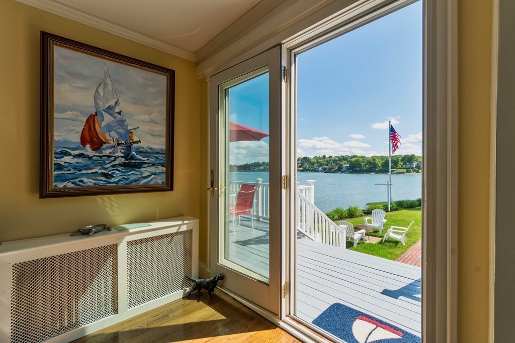 185 Downer Avenue Hingham, MA 02043 - Photo 15 of 30 a view of a hallway with wooden floor and a floor to ceiling window