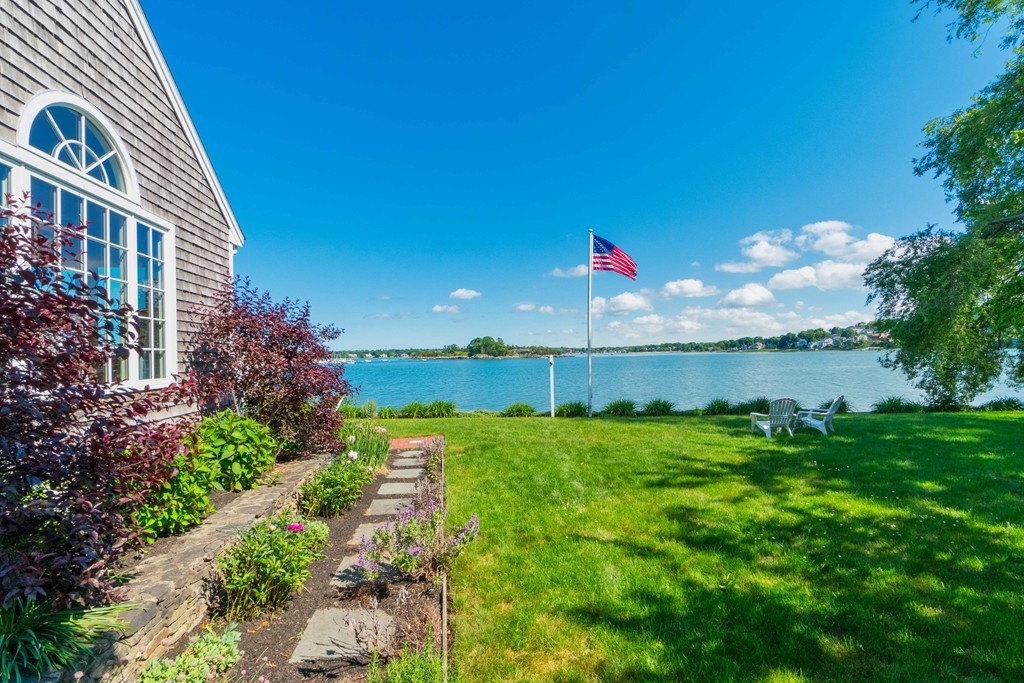 185 Downer Avenue Hingham, MA 02043 - Photo 27 of 30 a view of a house with a yard and table and chairs under an umbrella
