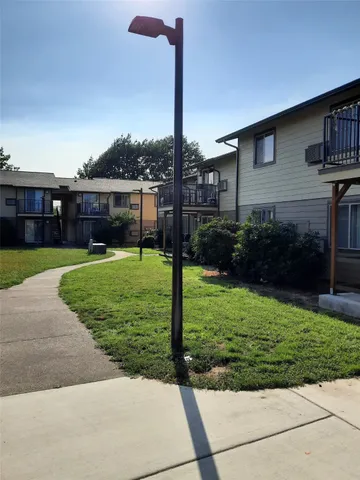 a view of a house with backyard and porch