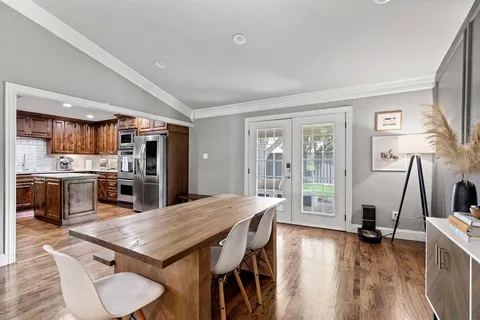 a kitchen with stainless steel appliances granite countertop wooden cabinets a sink dishwasher a stove and a refrigerator