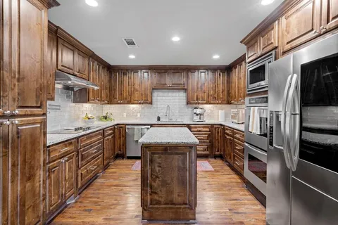 a bedroom with bed and wooden floor