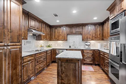 a bathroom with a granite countertop sink mirror and shower