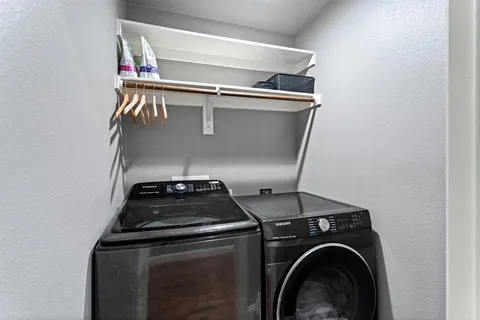 a bedroom with a bed and a flat tv screen on the dresser