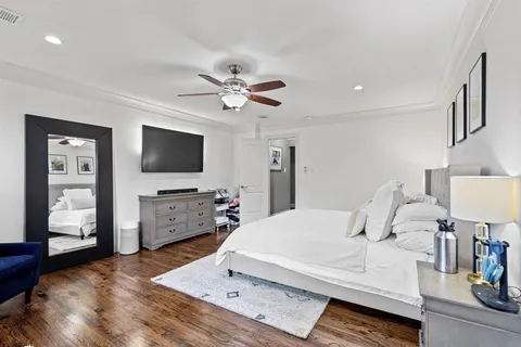 a bedroom with a bed and a chandelier