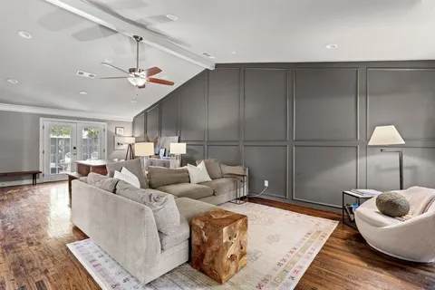 a living room with furniture and a ceiling fan