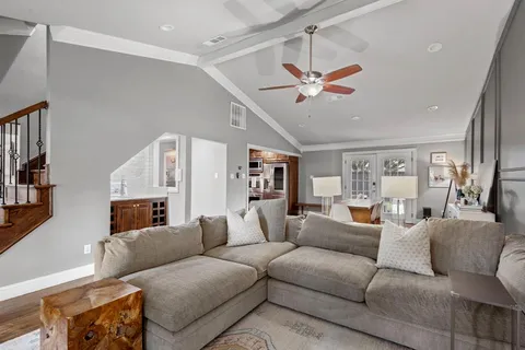 a living room with furniture a fireplace and a flat screen tv