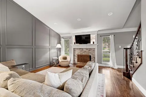 a living room with stainless steel appliances kitchen island granite countertop wooden floor a dining table and chairs with wooden floor