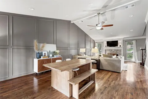 a large kitchen with a table and chairs in it