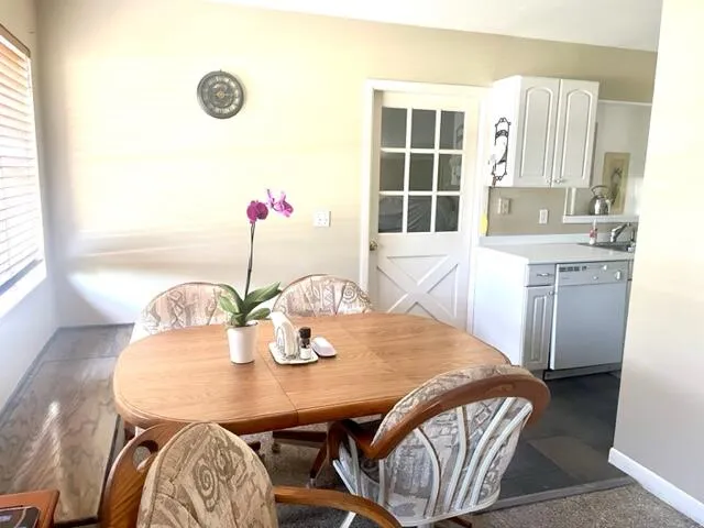 a view of a dining room with furniture and window