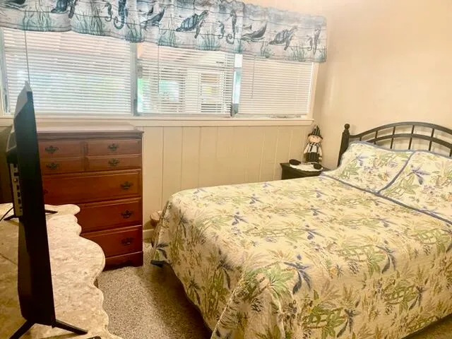 a bedroom with a bed and a mirror