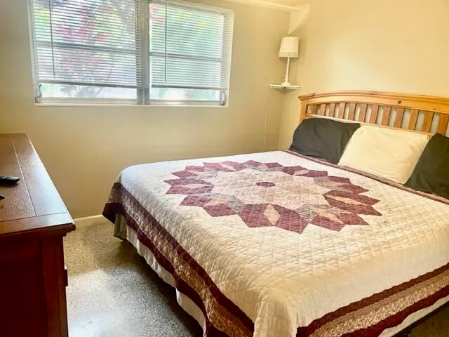 a bed sitting in a bedroom next to a window