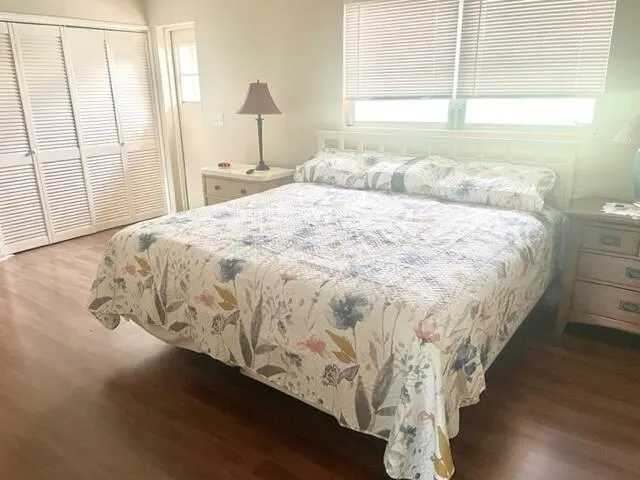 a large bed sitting in a bedroom next to a window