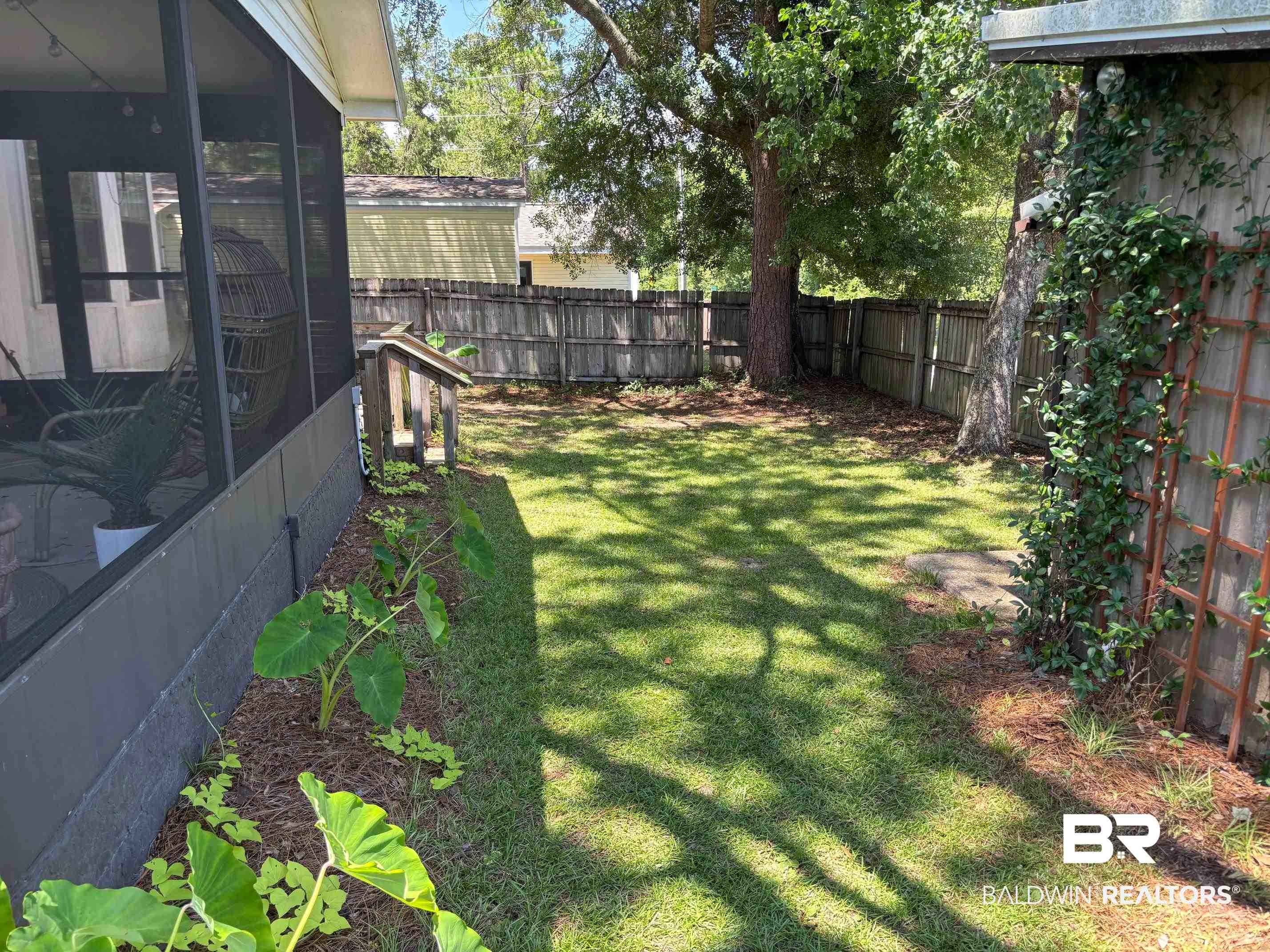 1434 Ridgewood Drive Lillian, AL 36549 - Photo 25 of 45 Fenced backyard with a sunroom