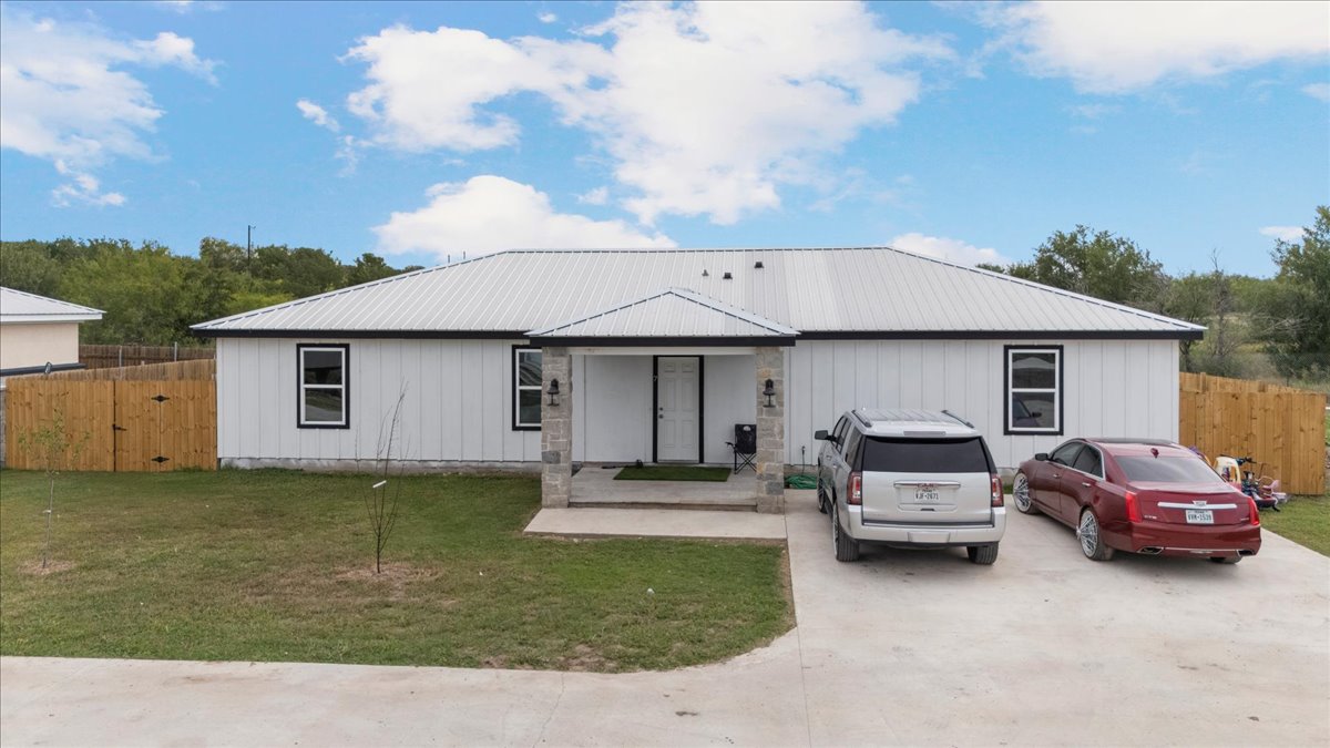 Tbd Williamson Road Kyle, TX 78640 - Photo 12 of 33 a front view of a house with a garden and cars parked