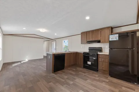 a kitchen with stainless steel appliances granite countertop a refrigerator and a sink