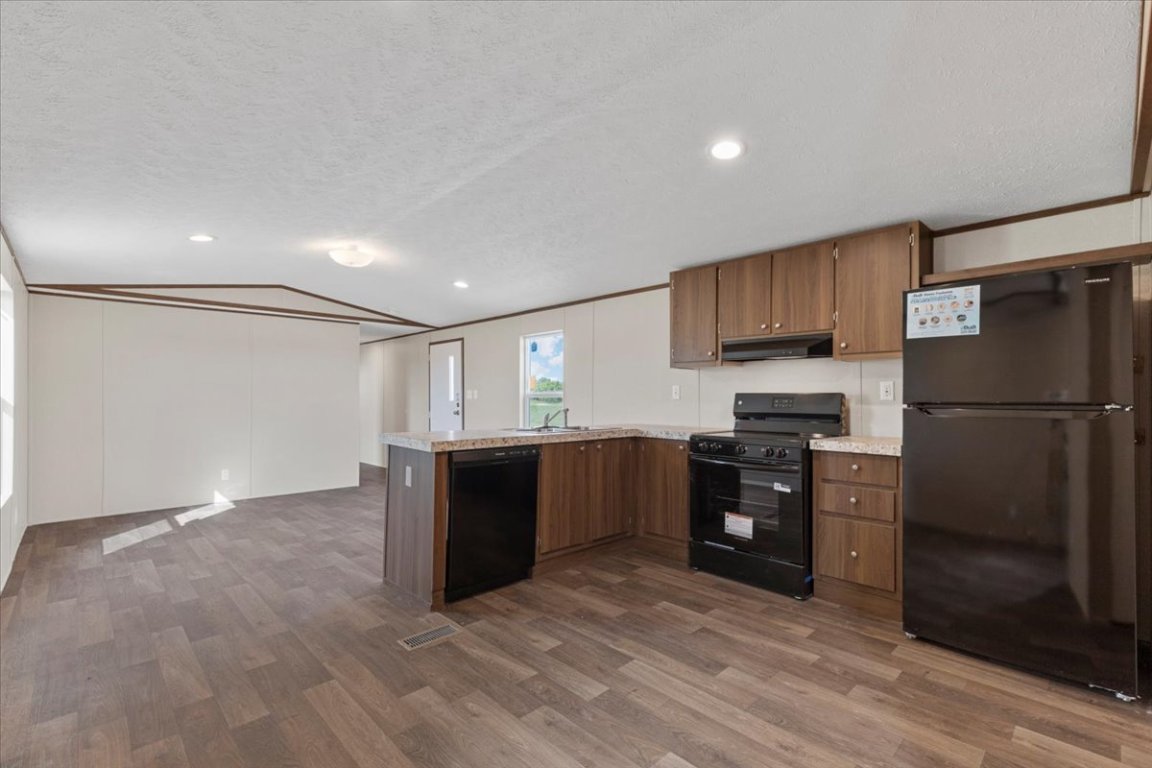 Tbd Williamson Road Kyle, TX 78640 - Photo 23 of 33 a kitchen with stainless steel appliances granite countertop a refrigerator and a stove top oven