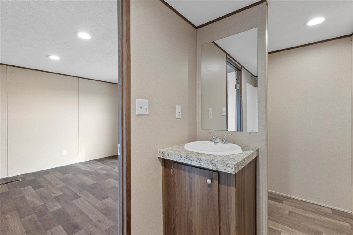 Tbd Williamson Road Kyle, TX 78640 - Photo 28 of 33 a bathroom with a granite countertop sink and a mirror