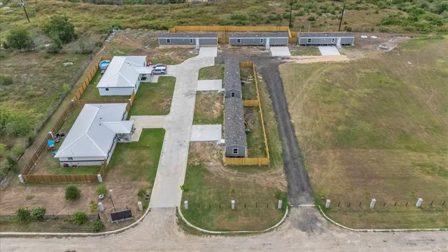 an aerial view of residential houses with outdoor space
