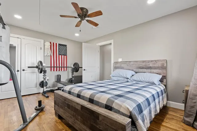 a bedroom with a bed and a large mirror