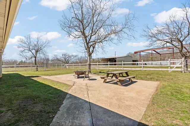 a view of a swimming pool with a table and chairs