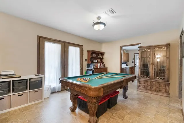 a room with pool table and flat screen tv