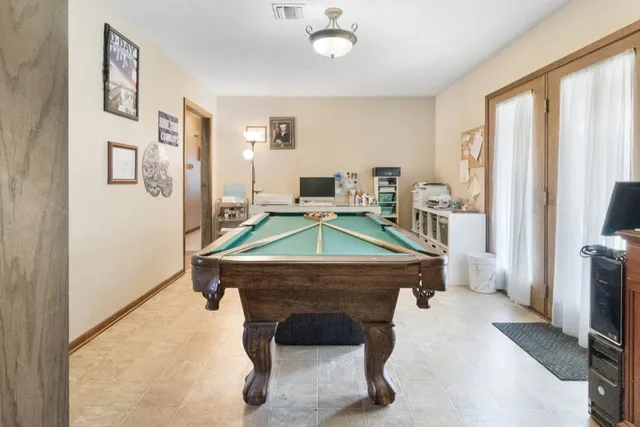 a room with furniture pool table and flat screen tv