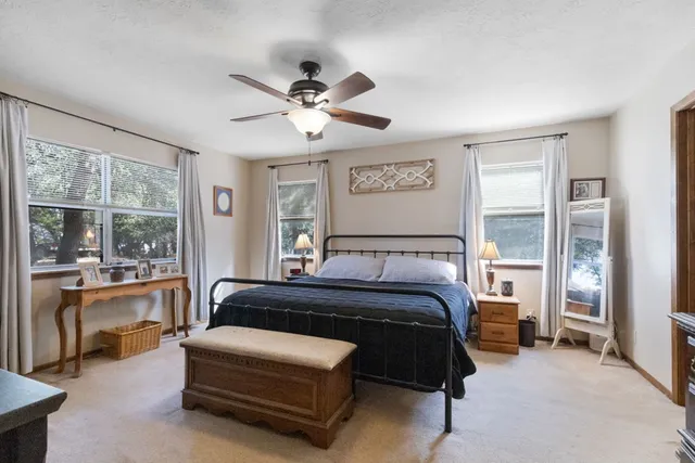 a bedroom with a bed couch and a window