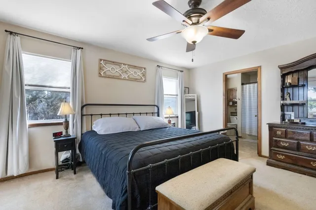 a living room with a bed furniture and a window