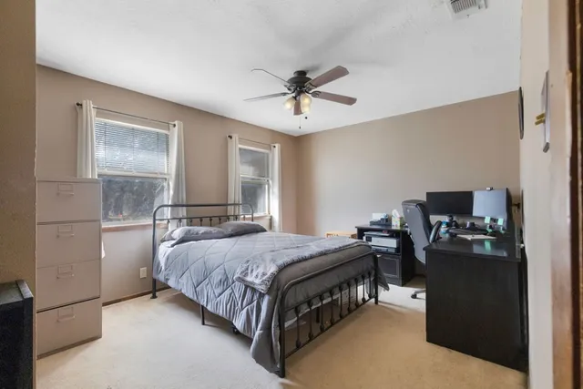 a bedroom with a bed and a chandelier