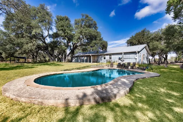 a view of a swimming pool with a yard