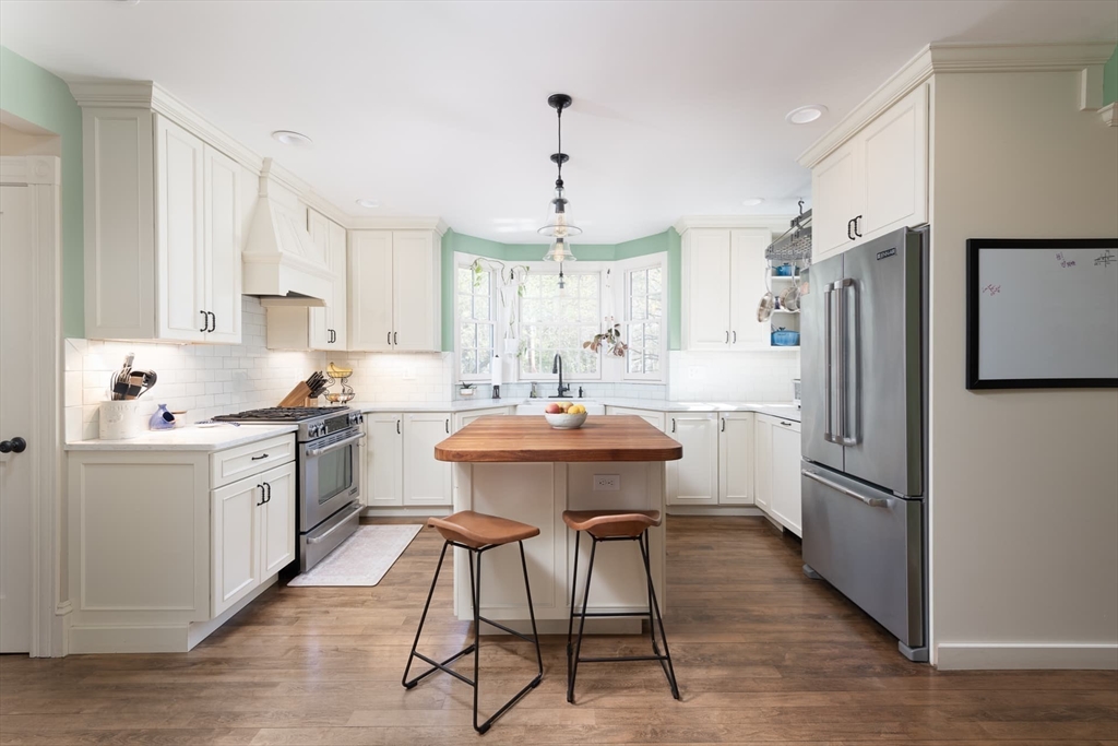 20 Maple Road Weston, MA 02493 - Photo 11 of 42 a kitchen with refrigerator a sink and chairs