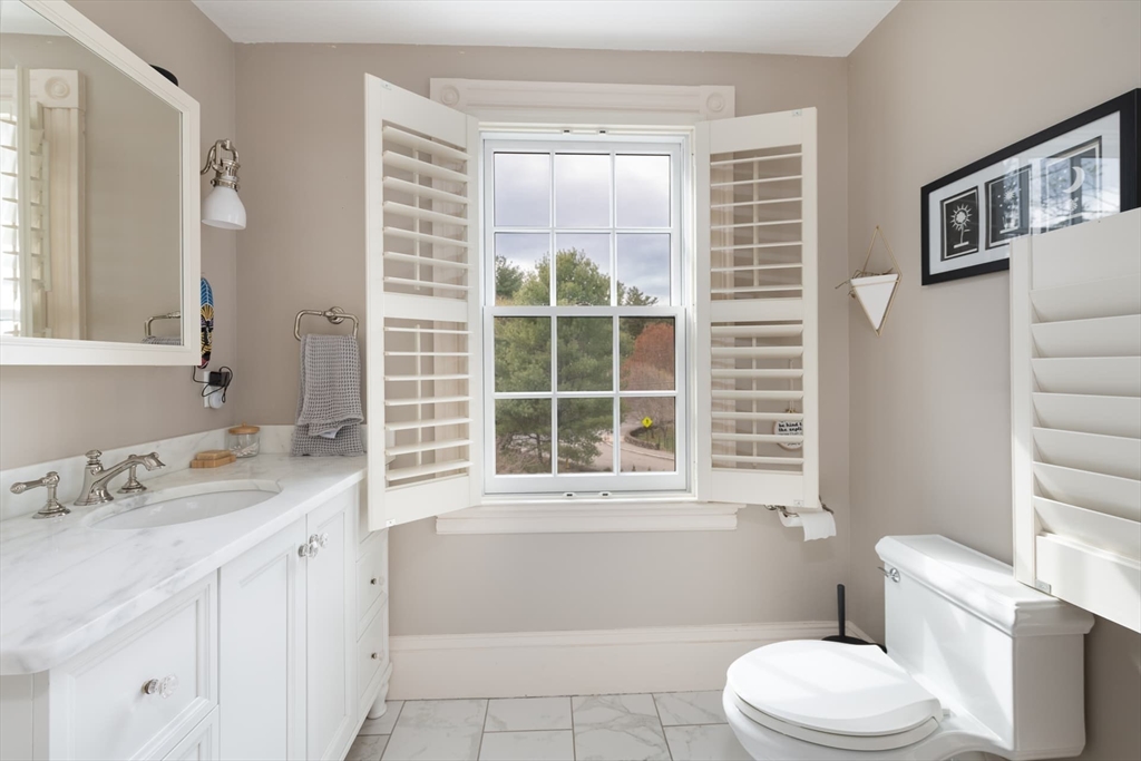 20 Maple Road Weston, MA 02493 - Photo 21 of 42 a bathroom with a sink a toilet and a window