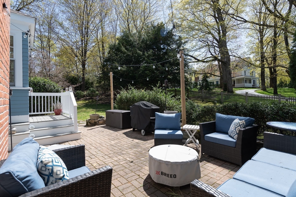 20 Maple Road Weston, MA 02493 - Photo 36 of 42 a view of a patio with couches chairs and a fire pit