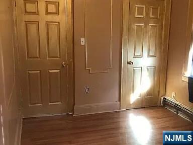 69 Hobson Street Newark, NJ 07112 - Photo 13 of 23 an empty room with wooden floor and windows