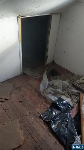 a room with water heater and wooden cabinets