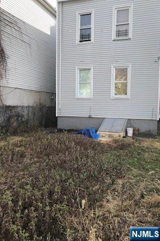 69 Hobson Street Newark, NJ 07112 - Photo 22 of 23 a front view of a house with a yard