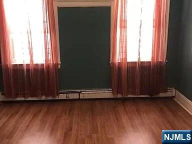 69 Hobson Street Newark, NJ 07112 - Photo 23 of 23 an view of wooden floor and brick walls