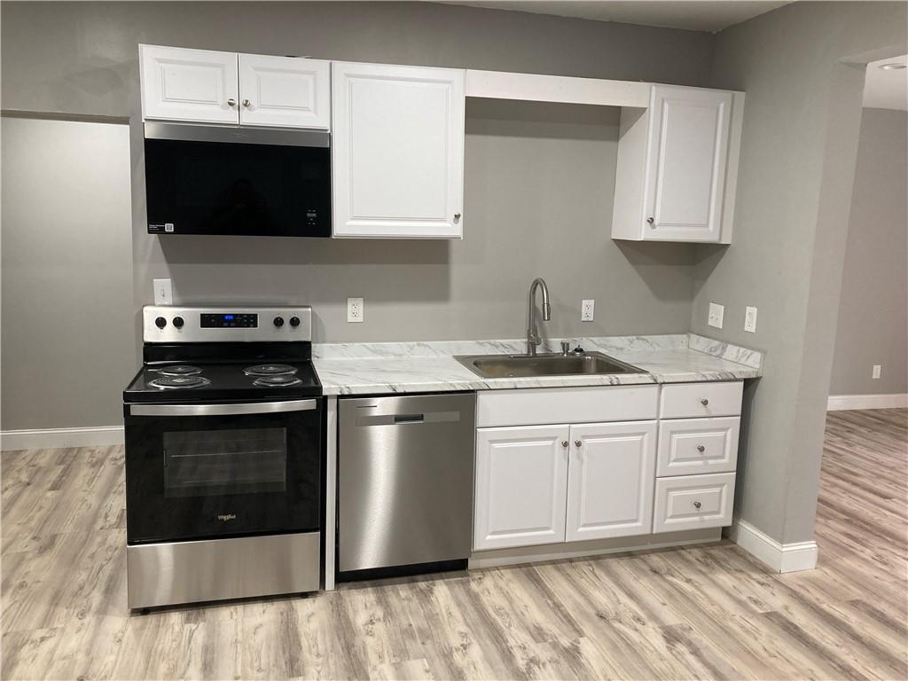 100 B Dickerson Road Dahlonega, GA 30533 - Photo 4 of 11 a kitchen with stainless steel appliances a stove a sink and a microwave