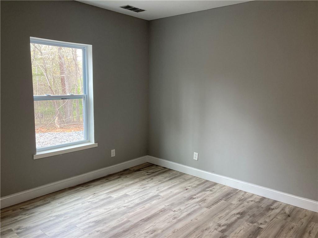 100 B Dickerson Road Dahlonega, GA 30533 - Photo 7 of 11 an empty room with wooden floor and windows