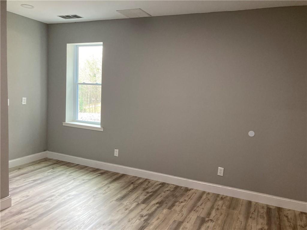 100 B Dickerson Road Dahlonega, GA 30533 - Photo 8 of 11 a view of an empty room with wooden floor and a window