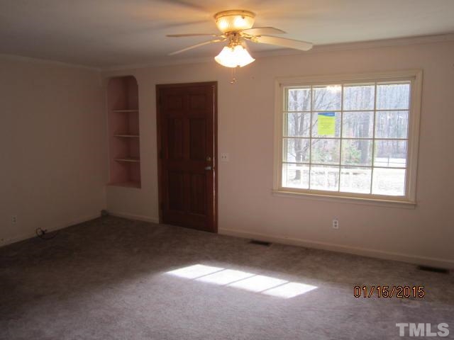 1427 Dirgie Mine Road Roxboro, NC 27574 - Photo 5 of 13 an empty room with windows and fan